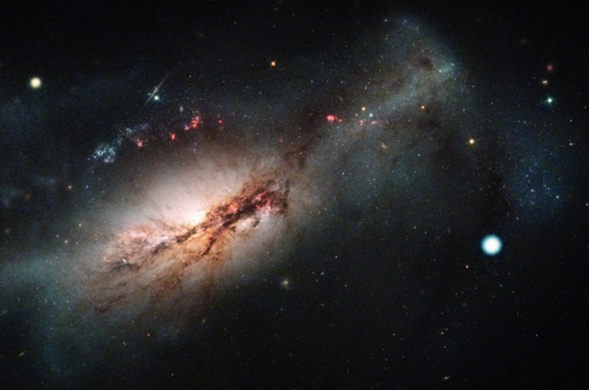 A Hubble Space Telescope image of the starburst galaxy NGC 2146 showing the position of the supernova SN 2018zd (large white dot on right), which was first detected in 2018.